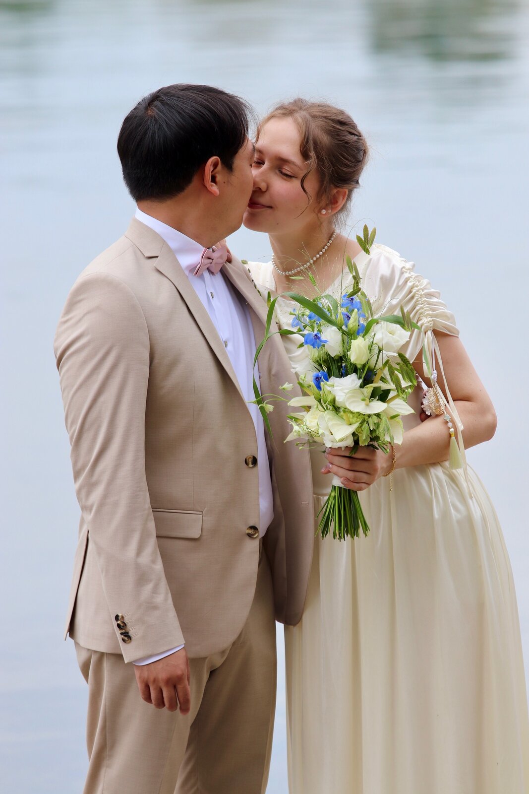 Yongjai and Vanessa kissing beside the water